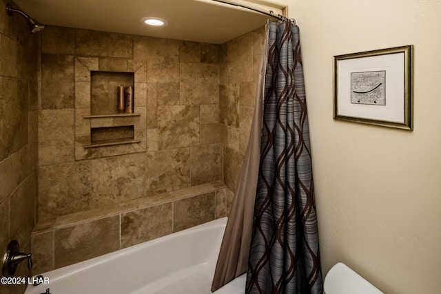 bathroom with shower / tub combo and toilet