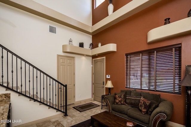 living room featuring a high ceiling