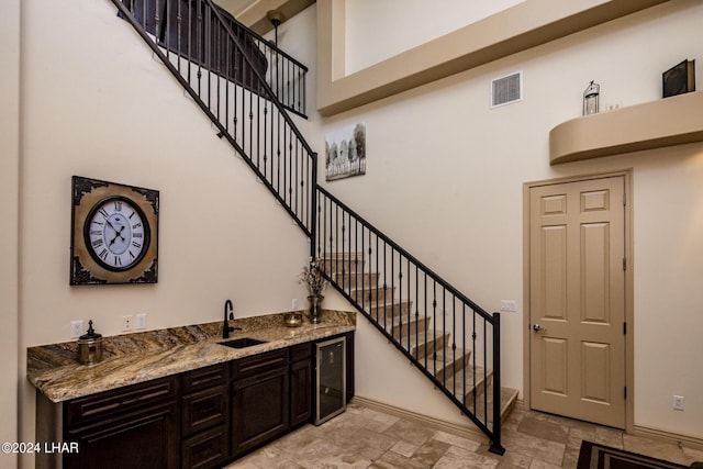 staircase with sink and a high ceiling