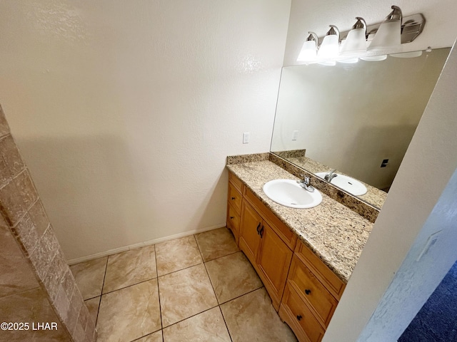 bathroom featuring vanity, baseboards, and tile patterned floors