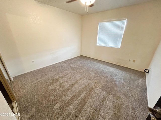 spare room featuring carpet flooring and a ceiling fan