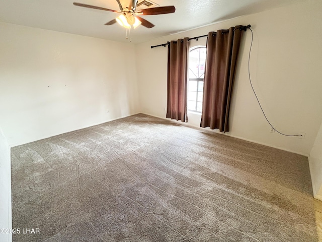 carpeted spare room with ceiling fan