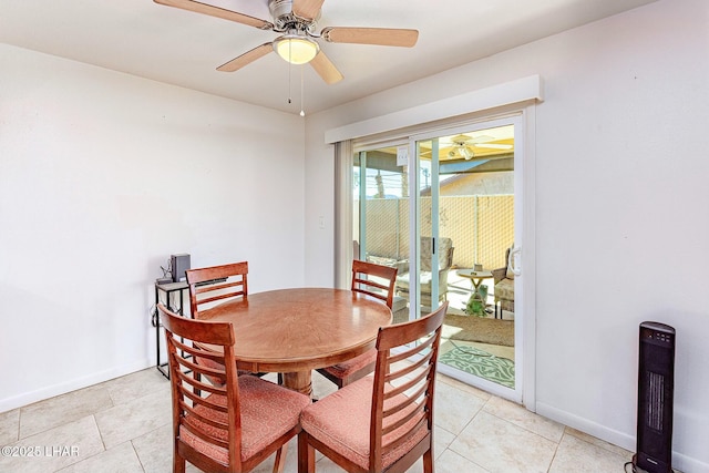 tiled dining space featuring ceiling fan