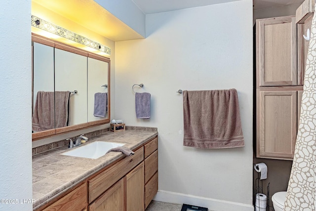 bathroom featuring vanity and toilet