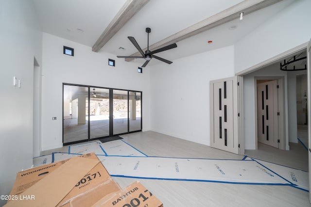 6724 Corte De Los Bueyes, Lake Havasu City, AZ 86404 - unfurnished living room featuring ceiling fan, beamed ceiling, and a high ceiling