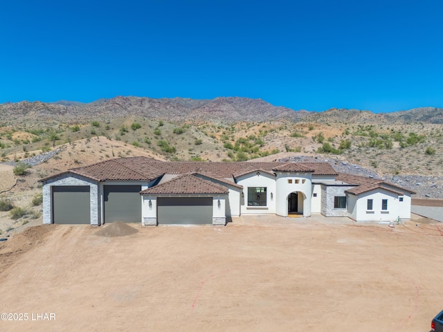 6724 Corte De Los Bueyes, Lake Havasu City, AZ 86404 - view of front of home with stucco siding, a mountain view, a garage, and a tiled roof