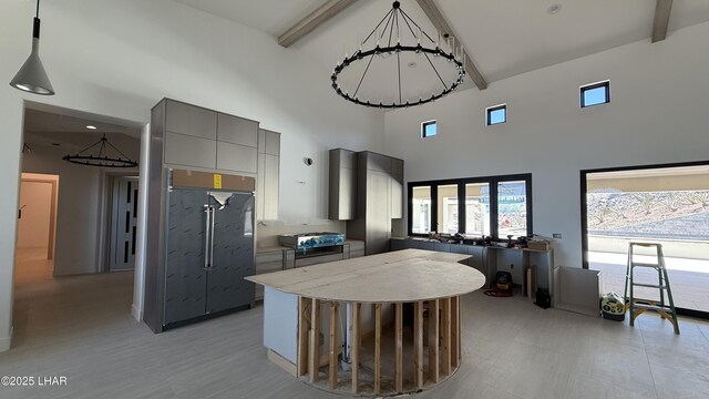 6724 Corte De Los Bueyes, Lake Havasu City, AZ 86404 - kitchen with gray cabinets, beam ceiling, a high ceiling, a kitchen island, and modern cabinets