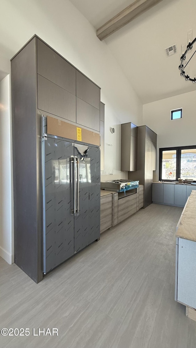 6724 Corte De Los Bueyes, Lake Havasu City, AZ 86404 - kitchen with high end refrigerator, gray cabinets, beam ceiling, light wood-style floors, and high vaulted ceiling