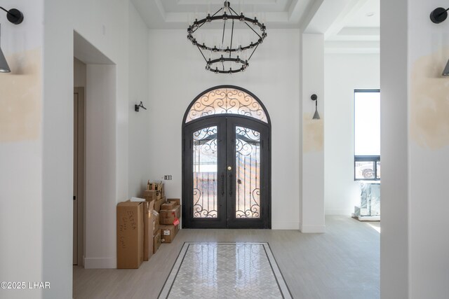 6724 Corte De Los Bueyes, Lake Havasu City, AZ 86404 - foyer with french doors, a chandelier, a tray ceiling, and a high ceiling