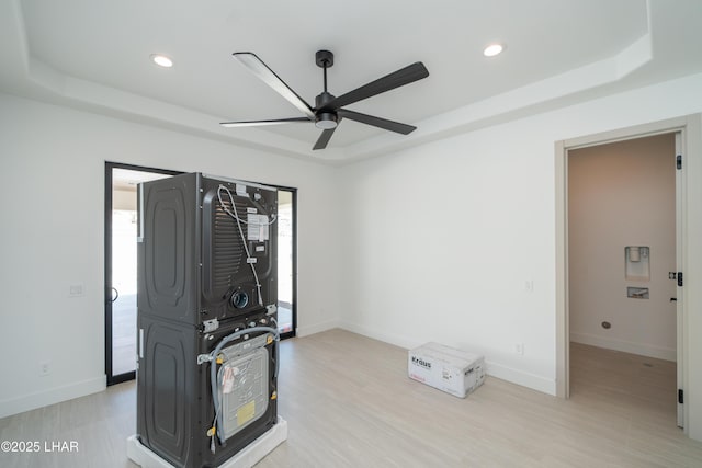 6724 Corte De Los Bueyes, Lake Havasu City, AZ 86404 - unfurnished room featuring stacked washing machine and dryer, a raised ceiling, ceiling fan, recessed lighting, and light wood-type flooring