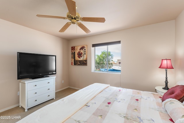 bedroom featuring light carpet, baseboards, and ceiling fan