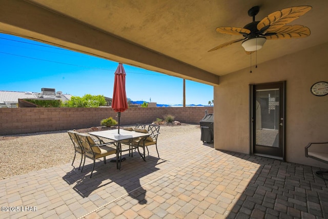 view of patio with outdoor dining space and a fenced backyard