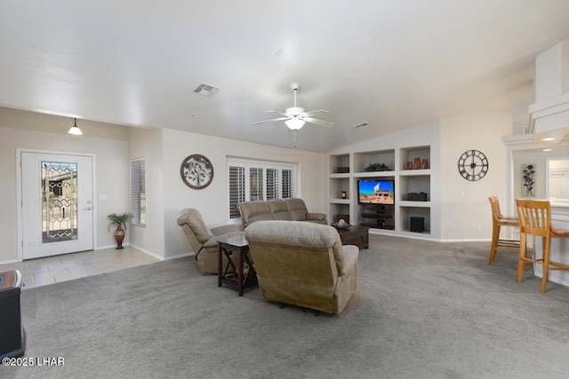 carpeted living area with visible vents, baseboards, ceiling fan, built in features, and vaulted ceiling