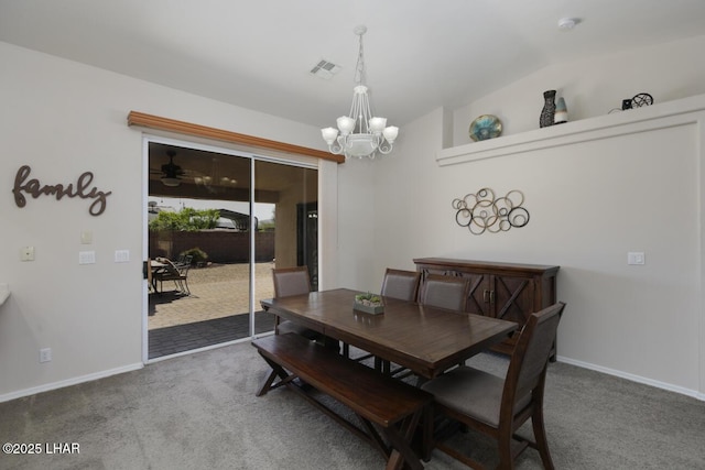 dining space featuring visible vents, carpet, an inviting chandelier, and vaulted ceiling