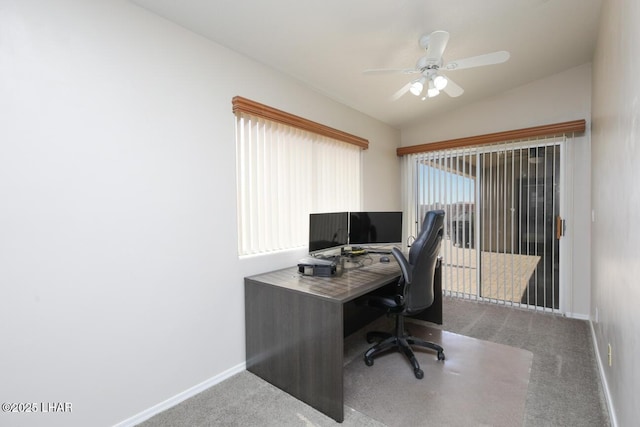 carpeted office space featuring ceiling fan, baseboards, and vaulted ceiling