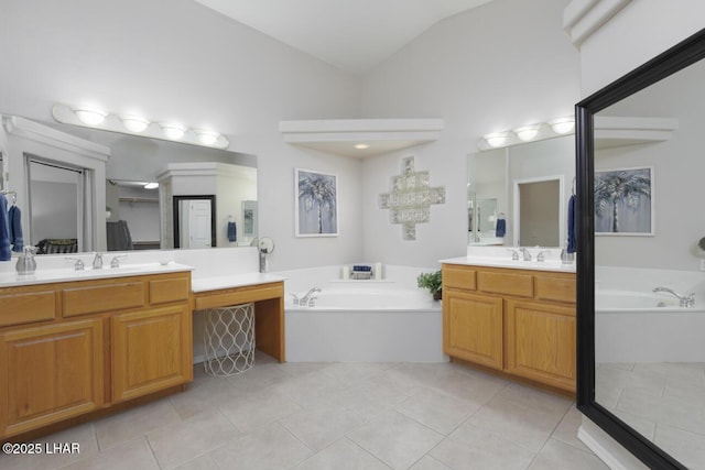 bathroom with lofted ceiling, two vanities, a sink, tile patterned flooring, and a bath