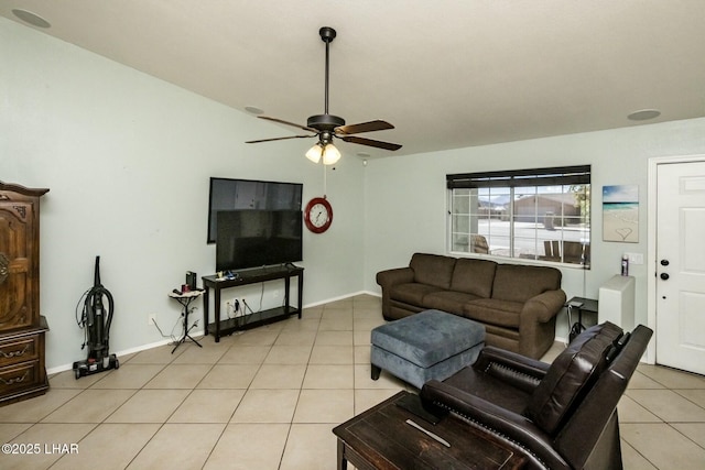 living area with a ceiling fan, baseboards, and light tile patterned floors