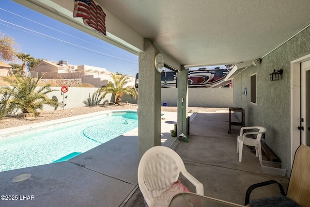 view of swimming pool featuring a fenced in pool, a fenced backyard, and a patio