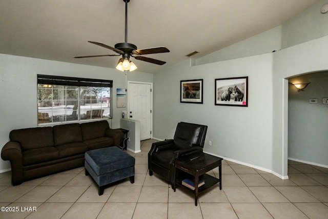 living area with lofted ceiling, light tile patterned floors, and visible vents