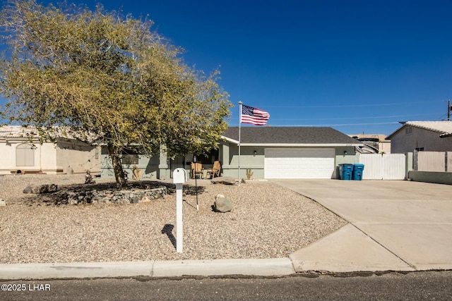 view of front of home featuring stucco siding, a shingled roof, concrete driveway, an attached garage, and fence