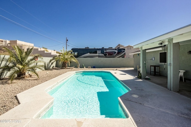 view of swimming pool featuring a patio area, a fenced backyard, and a fenced in pool