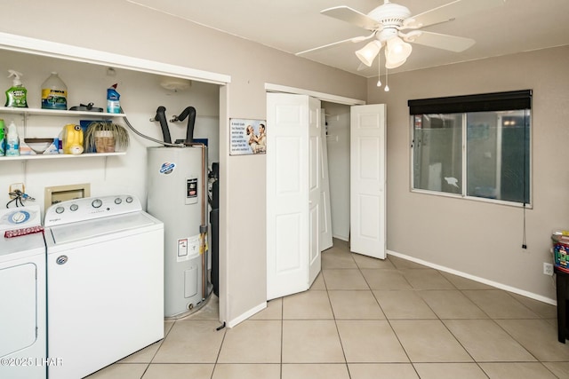 clothes washing area with light tile patterned floors, a ceiling fan, electric water heater, laundry area, and independent washer and dryer