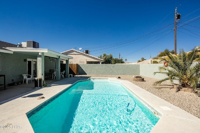 view of pool featuring a fenced in pool, a patio area, a fenced backyard, and central AC