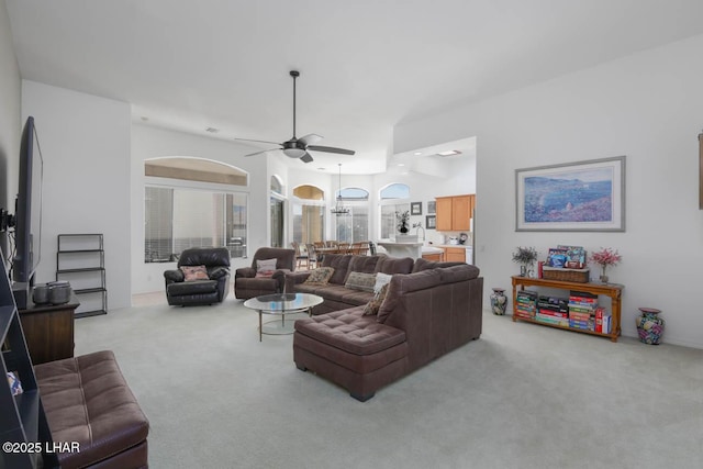living room featuring ceiling fan and light colored carpet