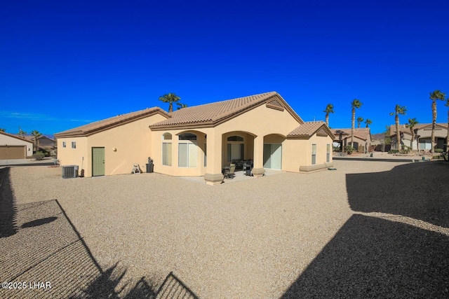 back of house with central AC and a patio