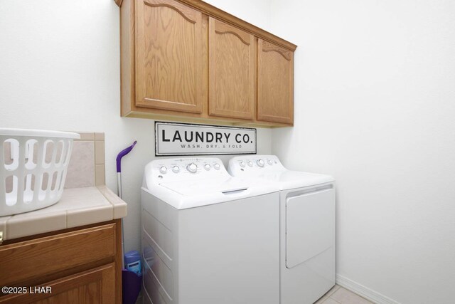 laundry room with cabinets and washer and dryer