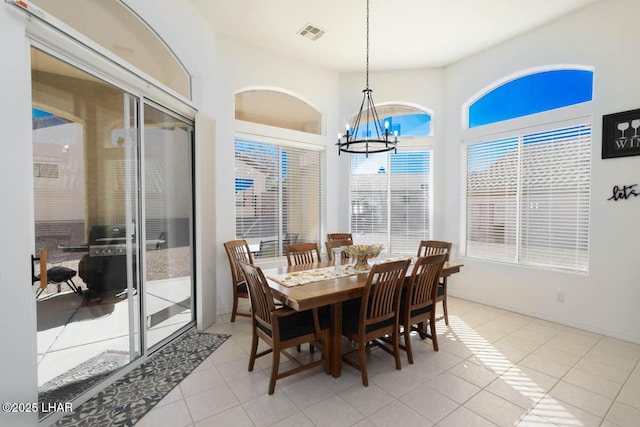 dining room with an inviting chandelier and light tile patterned floors