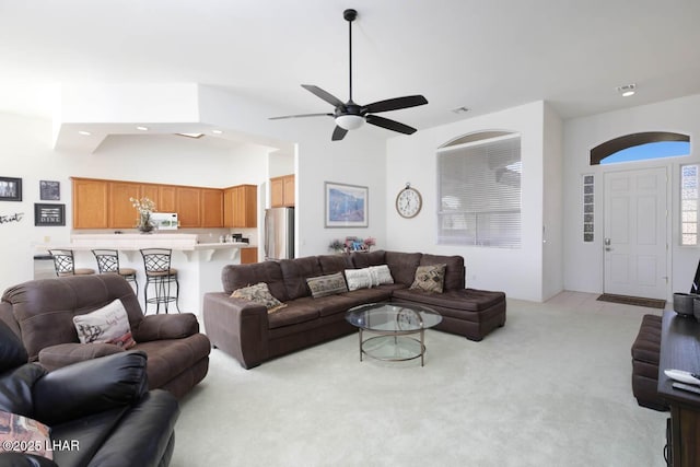 living room with light carpet and ceiling fan