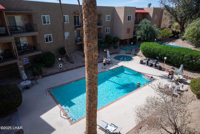 pool featuring a patio area and a community hot tub