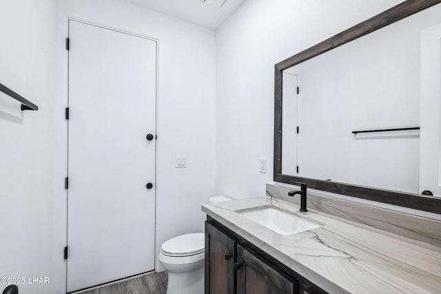 4801 N Diana Ave, Lake Havasu City, AZ 86404 - half bath featuring vanity, toilet, and wood finished floors