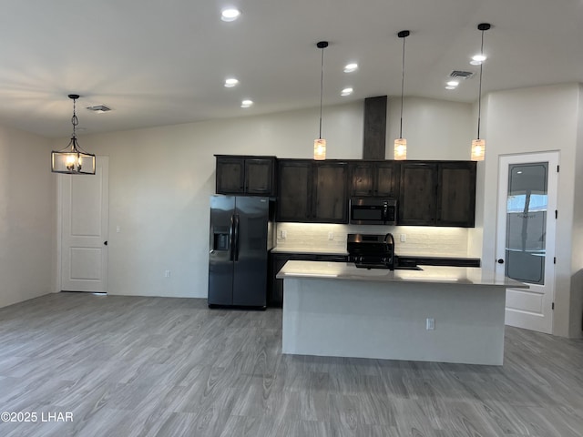 kitchen with visible vents, a sink, range with electric cooktop, black fridge with ice dispenser, and stainless steel microwave