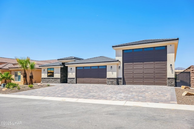 4801 N Diana Ave, Lake Havasu City, AZ 86404 - prairie-style house with stucco siding, stone siding, an attached garage, and a tile roof
