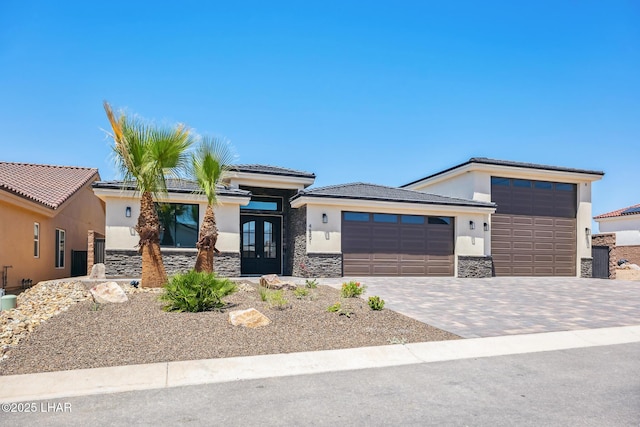 4801 N Diana Ave, Lake Havasu City, AZ 86404 - prairie-style home featuring stone siding, french doors, a garage, stucco siding, and driveway