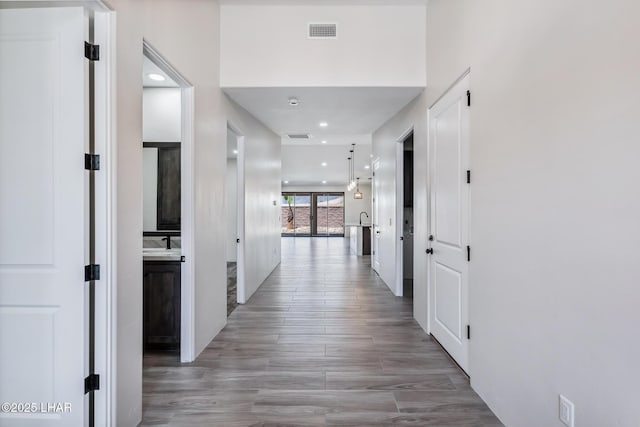 4801 N Diana Ave, Lake Havasu City, AZ 86404 - hallway featuring recessed lighting, a sink, and light wood-style floors