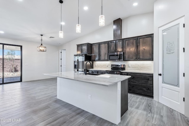 4801 N Diana Ave, Lake Havasu City, AZ 86404 - kitchen with stainless steel appliances, a sink, tasteful backsplash, light stone counters, and a center island with sink