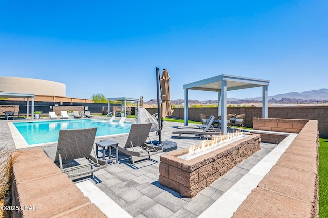 4801 N Diana Ave, Lake Havasu City, AZ 86404 - view of pool with an outdoor fire pit, a fenced backyard, a patio area, and a mountain view
