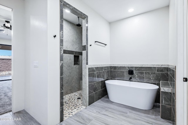 4801 N Diana Ave, Lake Havasu City, AZ 86404 - bathroom featuring a freestanding bath, a walk in shower, tile walls, recessed lighting, and wainscoting