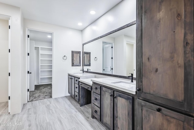 4801 N Diana Ave, Lake Havasu City, AZ 86404 - bathroom featuring double vanity, a spacious closet, recessed lighting, and wood finished floors