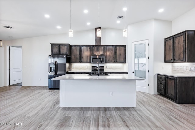 4801 N Diana Ave, Lake Havasu City, AZ 86404 - kitchen featuring black refrigerator with ice dispenser, stainless steel microwave, tasteful backsplash, light countertops, and recessed lighting