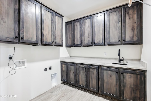 4801 N Diana Ave, Lake Havasu City, AZ 86404 - laundry room featuring hookup for a washing machine, cabinet space, light wood-type flooring, and hookup for an electric dryer