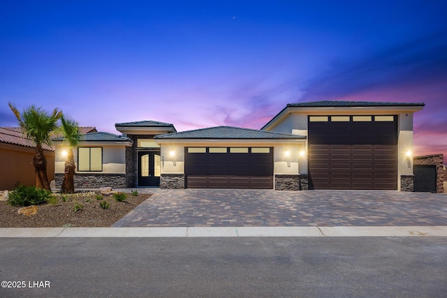 4801 N Diana Ave, Lake Havasu City, AZ 86404 - prairie-style house featuring an attached garage, stone siding, driveway, stucco siding, and a tiled roof