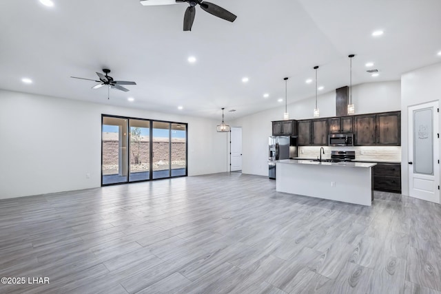 4801 N Diana Ave, Lake Havasu City, AZ 86404 - unfurnished living room featuring a ceiling fan, vaulted ceiling, recessed lighting, light wood-style flooring, and a sink
