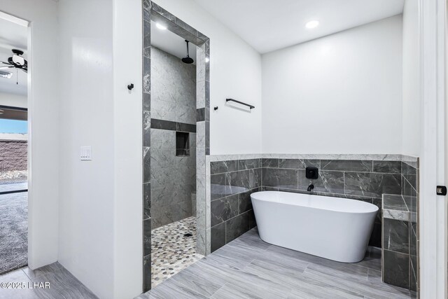 4801 N Diana Ave, Lake Havasu City, AZ 86404 - bathroom featuring a freestanding bath, a walk in shower, tile walls, recessed lighting, and wainscoting