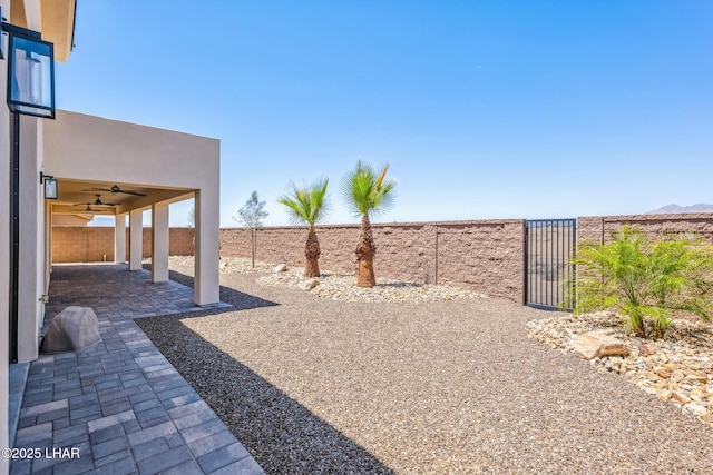 4801 N Diana Ave, Lake Havasu City, AZ 86404 - fenced backyard featuring a gate, ceiling fan, and a patio area
