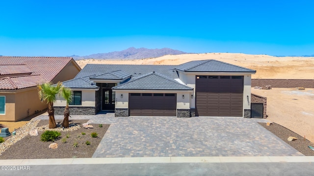 4801 N Diana Ave, Lake Havasu City, AZ 86404 - view of front of home featuring stucco siding, a garage, stone siding, and a mountain view