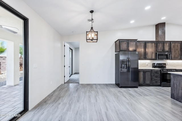 4801 N Diana Ave, Lake Havasu City, AZ 86404 - kitchen with black fridge, electric stove, stainless steel microwave, light wood-style floors, and pendant lighting